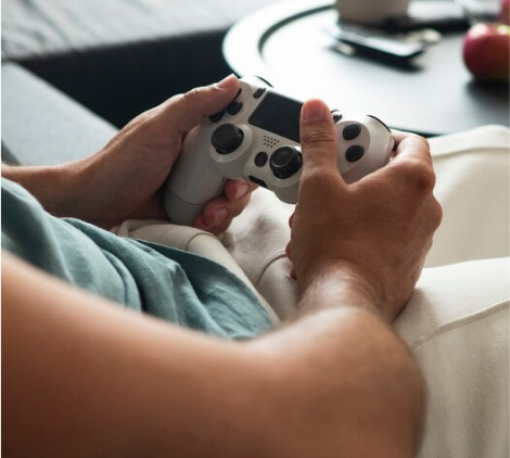 A person playing video games as a symbol of ADHD and gaming addiction.