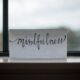 Paper with Mindfulness printed on it on a window sill