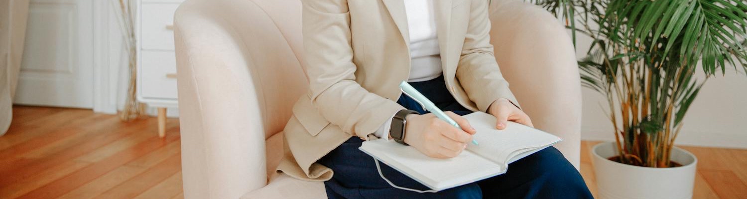 A therapist taking notes while talking to a patient