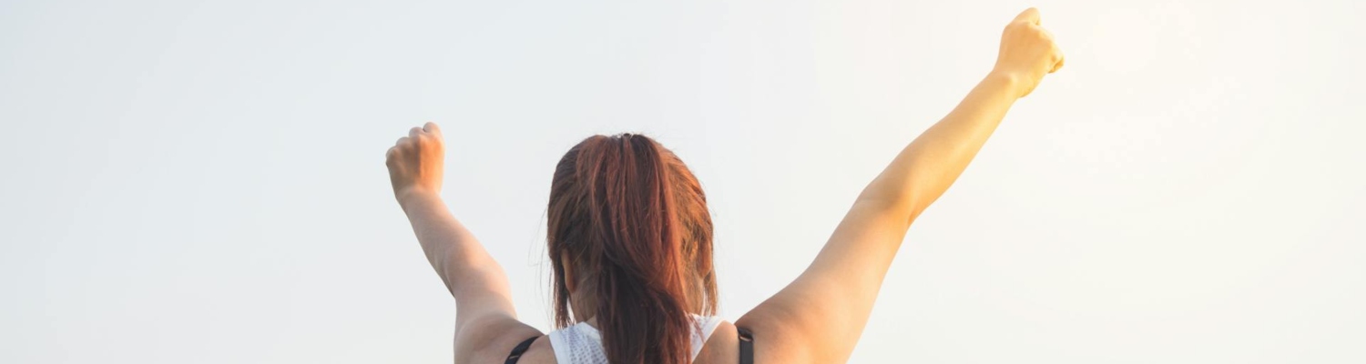 woman celebrating after learning how to rebuild your life 