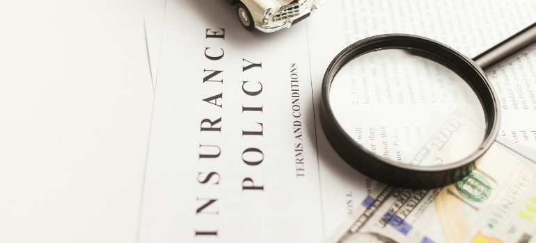 Magnifying glass on top of an insurance policy